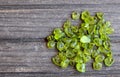 Olivine gemstone also called Peridot on old wooden background.