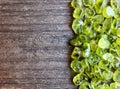 Olivine gemstone also called Peridot on old wooden background. Royalty Free Stock Photo