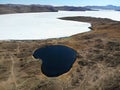 Olkhon Island in the spring. Beautiful aerial view of the frozen bay of Lake Baikal and the heart-shaped Lake Nuku-Nur