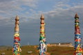 Olkhon / Russia - 27 June 2019: Shaman rock at lake Baikal with the sunset light. The bars of the hitching post tied with ribbons Royalty Free Stock Photo