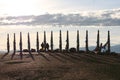 Olkhon / Russia - 27 June 2019: Shaman rock at lake Baikal with the sunset light. The bars of the hitching post tied with ribbons Royalty Free Stock Photo