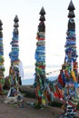 Shaman rock at lake Baikal with the sunset light. The bars of the hitching post tied with ribbons on Olkhon island. Beautiful summ Royalty Free Stock Photo