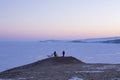 Olkhon, Siberia, Russia- February 23, 2023 : People meet the sunrise on Shamanka. Olkhon island on winter Baikal lake at Royalty Free Stock Photo