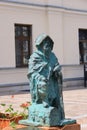 Market square in a small town near Krakow, bronze figure of a miner in the middle of the square, Olkusz, Poland