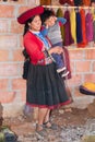 Ollantaytambo, Peru - circa June 2015: Women in traditional Peruvian clothes holds a boy near Cusco, Peru Royalty Free Stock Photo
