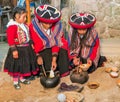 Ollantaytambo, Peru - circa June 2015: Women in traditional Peruvian clothes use natural dyes for Alpaca and Llama wool near Cusco Royalty Free Stock Photo