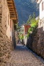 Ollantaytambo, Urubamba/Peru - circa June 2015: Old narrow street and brick buildings in Ollantaytambo Inca town Royalty Free Stock Photo