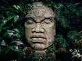 Olmec sculpture carved from stone. Big stone head statue in a jungle