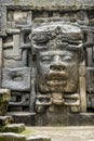 The Olmec style mask on the side of the Mayan temple of Lamanai in Belize Royalty Free Stock Photo