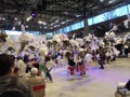 Olomouc, Czech - 04 27 2018: Multiple bouquets in white paper hanging from the ceiling in a hall of Flora Exposition with people Royalty Free Stock Photo