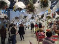 Olomouc, Czech - 04 27 2018: Multiple bouquets in white paper hanging from the ceiling over people in a hall of Flora Exposition Royalty Free Stock Photo