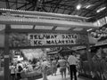 Retro image - Red Gateway at the entrance of Malay themed Flora Exposition with gladiola flowers and tourists.