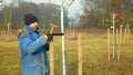 OLOMOUC, CZECH REPUBLIC, DECEMBER 15, 2019: Planting fruit trees on meadow near floodplain forest. White protects