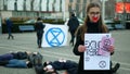 Olomouc, Czech Republic, January 10, 2019: Extinction rebellion activist Anna Martinkova banner symbol circle hourglass