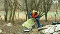 OLOMOUC, CZECH REPUBLIC, JANUARY 2, 2019: Man collect garbage rubbish gathers bag, forest landscape in endangered nature