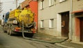 OLOMOUC, CZECH REPUBLIC, JANUARY, 30, 2021: Septic cesspool emptying pumping into pipe tank truck suction hose under Royalty Free Stock Photo