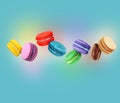 ÃÂ¡olored macaroons with different flavors in the air on a blue background