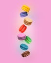 ÃÂ¡olored macaroons with different flavors in the air on pink background