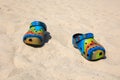 ÃÂ¡olorful crocs footwear on the beach, vacation background. ÃÂ¡olorful trendy croc beach shoes.