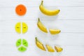 ÃÂ¡olorful math fractions and bananas as a sample on white wooden background or table. Interesting creative funny math for kids