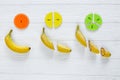 ÃÂ¡olorful math fractions and bananas as a sample on white wooden background or table. Interesting creative funny math for kids