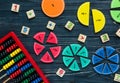 ÃÂ¡olorful math fractions on dark wooden background or table. Interesting creative funny math for kids. Education, back to school