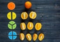 ÃÂ¡olorful math fractions and oranges as a sample on dark wooden background or table. Interesting creative funny math for kids