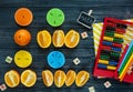 ÃÂ¡olorful math fractions and oranges as a sample on dark wooden background or table. Interesting creative funny math for kids.