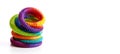 Colorful slinky toy on white background. Plastic rainbow spiral tube. 3d render illustration