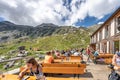 Olpererhutte, Austria - Aug 7, 2020: Tourists have food at wooden restaurant hostel