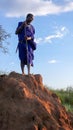 Olpopongi, Kilimanjaro Province / Tanzania: 29. December 2015: young Tanzania Masai warrior in traditional clothing digs in a Royalty Free Stock Photo