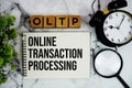 OLTP Online Transaction Processing text with alarm clock and magnifying glass on marble background Royalty Free Stock Photo