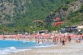 Oludeniz, Turkey - May 25, 2019: Turkey beach in Oludeniz with lot of people. Crowd of people relax on a coasline.