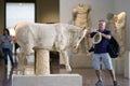 Olympia, Greece, July 17, 2018, A tourist takes photos of the archaeological finds in the museum Royalty Free Stock Photo