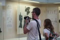 Olympia, Greece, July 17, 2018, A young tourist takes photos of the archaeological finds in the museum Royalty Free Stock Photo