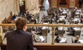 Young man sits in gallery and watches legislative procedings