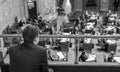 Black and white image of a young man sitting in the gallery of the capitol building