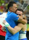 Olympic champion Eleftherios Petrounias of Greece R with his coach after Men`s Rings Final on artistic gymnastics competition