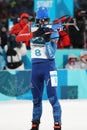 Olympic champion Martin Fourcade of France competes in biathlon men`s 12.5km pursuit at the 2018 Winter Olympics Royalty Free Stock Photo