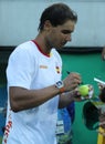 Olympic champion Rafael Nadal of Spain gives autographs after men`s singles semifinal of the Rio 2016 Olympic Games Royalty Free Stock Photo