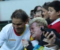 Olympic champion Rafael Nadal of Spain with tennis fan after men`s singles semifinal of the Rio 2016 Olympic Games Royalty Free Stock Photo