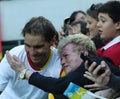 Olympic champion Rafael Nadal of Spain with tennis fan after men`s singles semifinal of the Rio 2016 Olympic Games Royalty Free Stock Photo