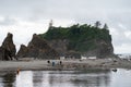 Olympic National Park, Washington - July 7, 2019: Tourists enjoy frolicking around on near the seastacks of Ruby Beach