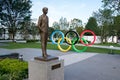 Olympic rings and statue of Pierre de Coubertin close to the Tokyo new national stadium Royalty Free Stock Photo