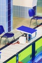 Olympic-sized swimming pool with starting blocks with yellow touch panels for a competition