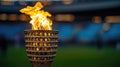 Olympic torch burning brightly in a stadium setting Royalty Free Stock Photo