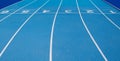 Olympic track lanes with white stripes and start and finish numbers, empty Blue background for copy space, concept of physical Royalty Free Stock Photo