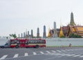 Thailand red public bus service in Bangkok with Thai royal palace view at the background. Royalty Free Stock Photo