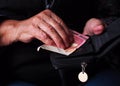 Woman`s hands are holding a few euro coins. Pension, poverty, social problems and the theme of old age. Royalty Free Stock Photo