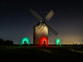 Night photograph of a windmill with the silhouette of don Xijote Royalty Free Stock Photo